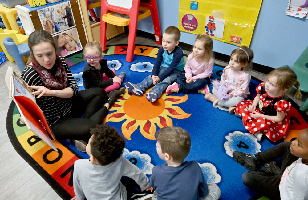 MARC SCHULTZ/GAZETTE PHOTOGRAPHER
Kristin Krofft reading to children at A Magic Kingdom Nursery and Day Care Center