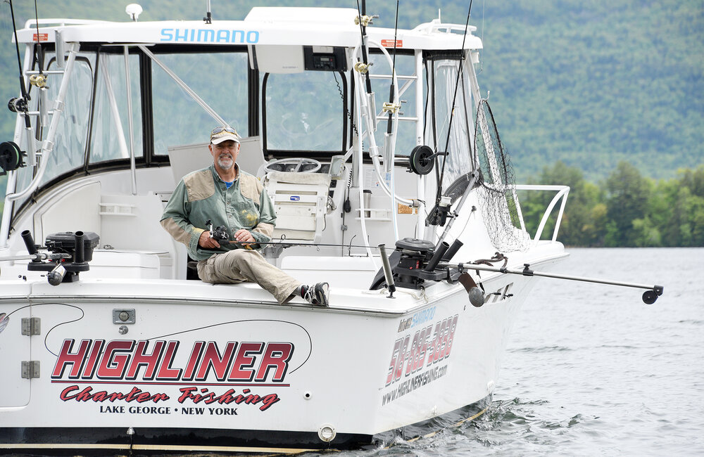 ERICA MILLER/GAZETTE PHOTOGRAPHER  
Justin Mahoney, owner of Lake George Island Adventures (pontoon excursions) and Highline Charter Fishing, where he docks at Lake George Suites in Lake George on Thursday, May 30, 2019.
