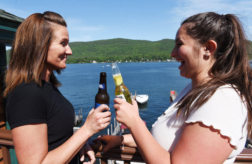 ERICA MILLER/GAZETTE PHOTOGRAPHER  
Gina Mitchell, (left) of Lake George, and Cate Hagan, of Queensbury, enjoy beers on the patio at King Neptunes in the Village of Lake George in Lake George on Sunday, June 9, 2019.