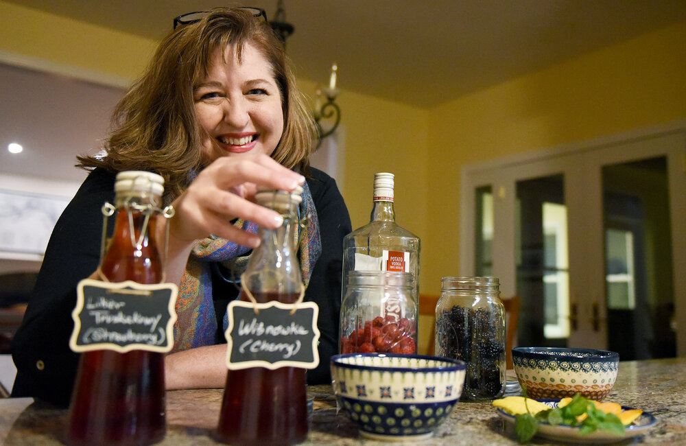 ERICA MILLER/GAZETTE PHOTOGRAPHER  
Anntonette Zembrzuski Alberti at her home kitchen with her homemade nalewki, a family polish tradition, made with sugar, vodka, spices, and fruit, in Saratoga Springs on Friday, November 8, 2019.