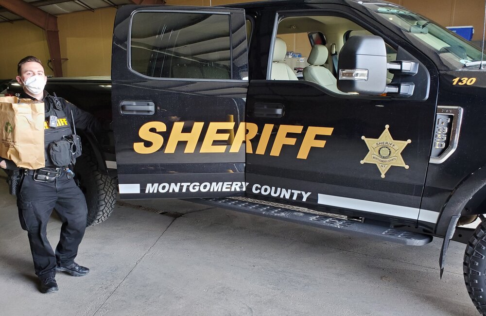 Photo provided: Montgomery County Deputy Sheriff Corey Rust loading in bags of food to deliver to county residents. 
